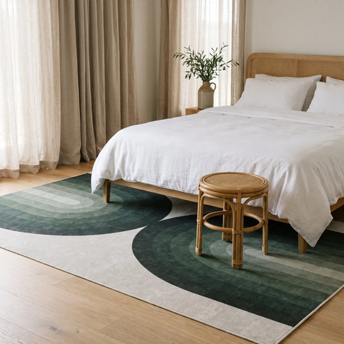 Absida Sage Rug in a bedroom