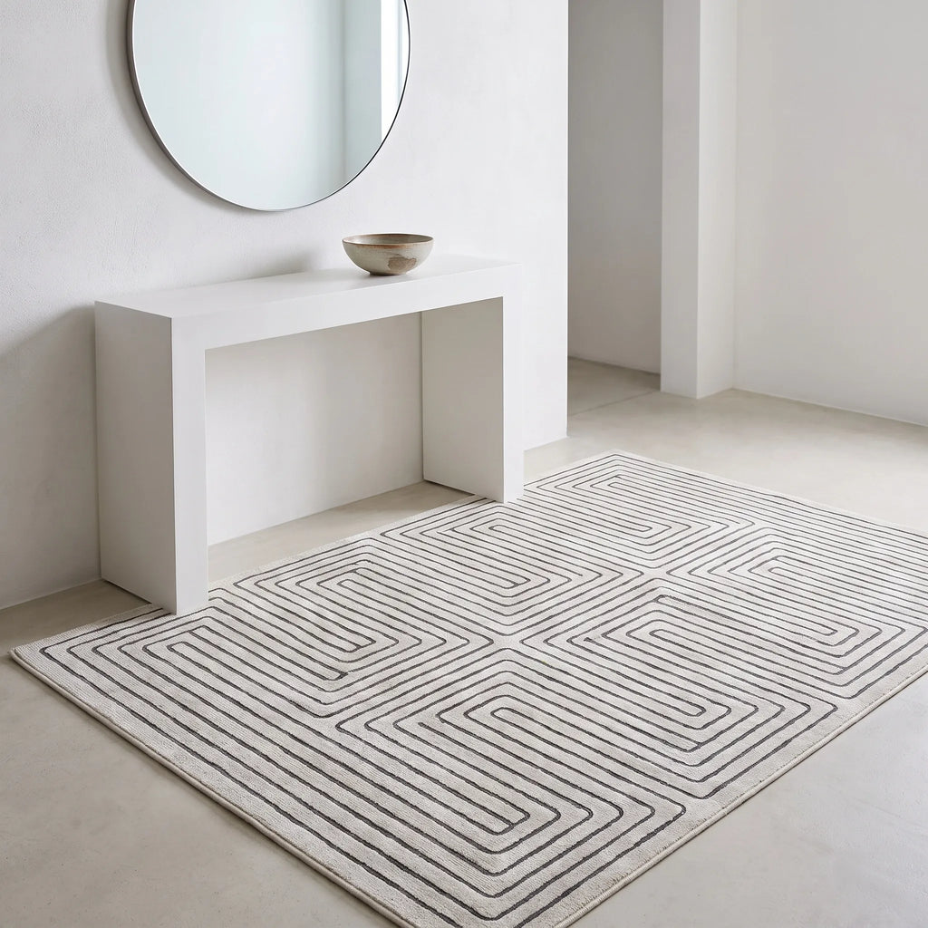 Labyrinth Black and Ivory Rug in an entryway