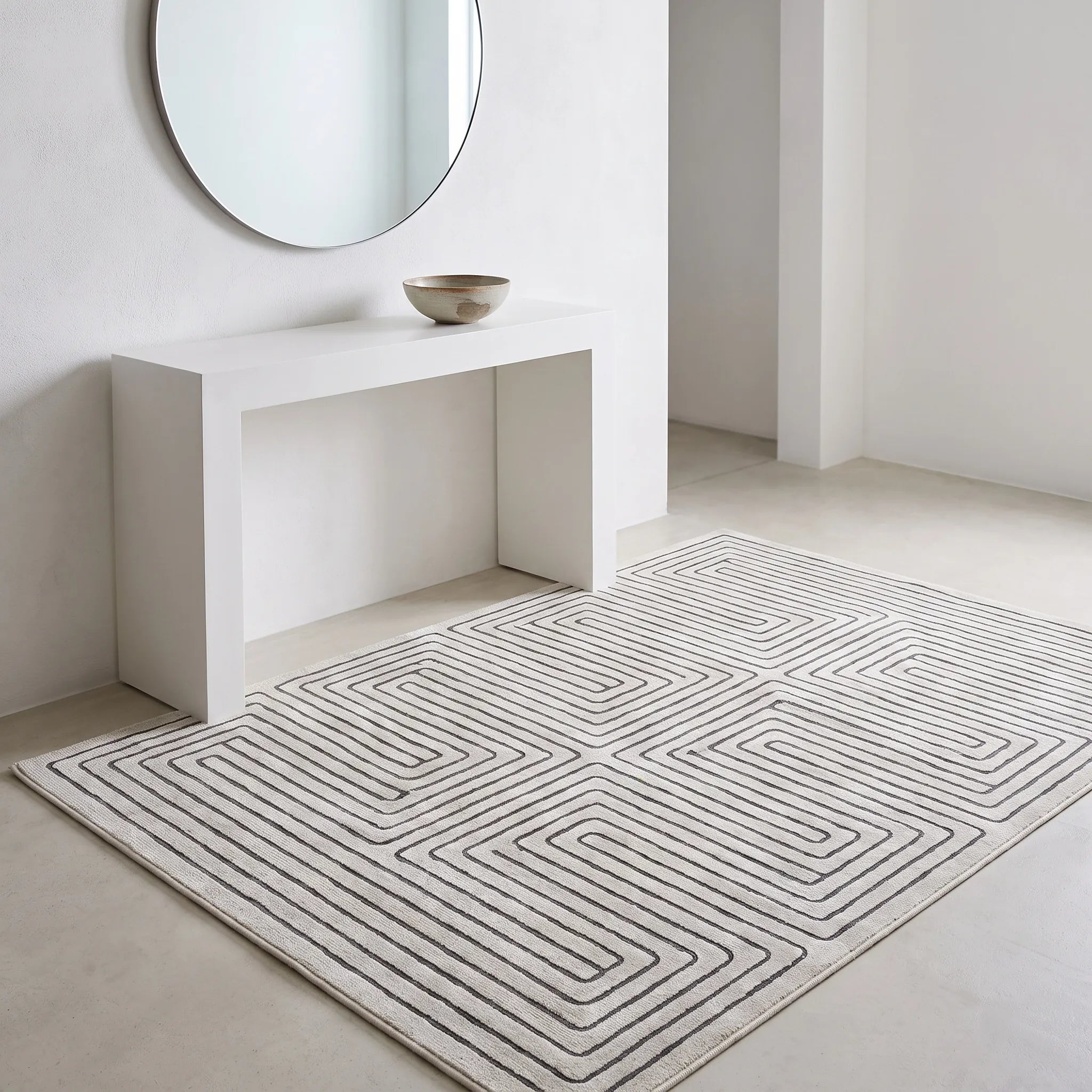 Labyrinth Black and Ivory Rug in an entryway