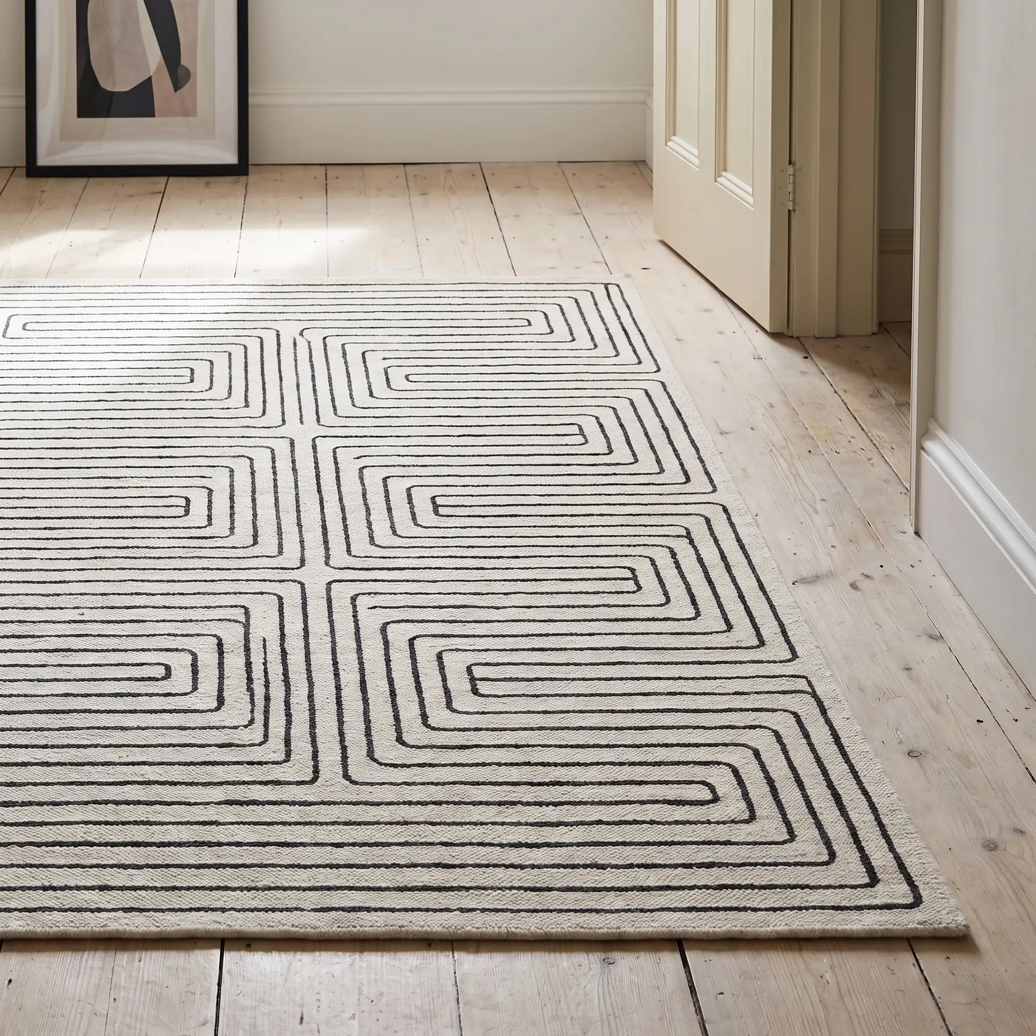 Labyrinth Black and Ivory Rug in a hallway