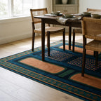 Nerissa Teal and Gold Rug in a dining room